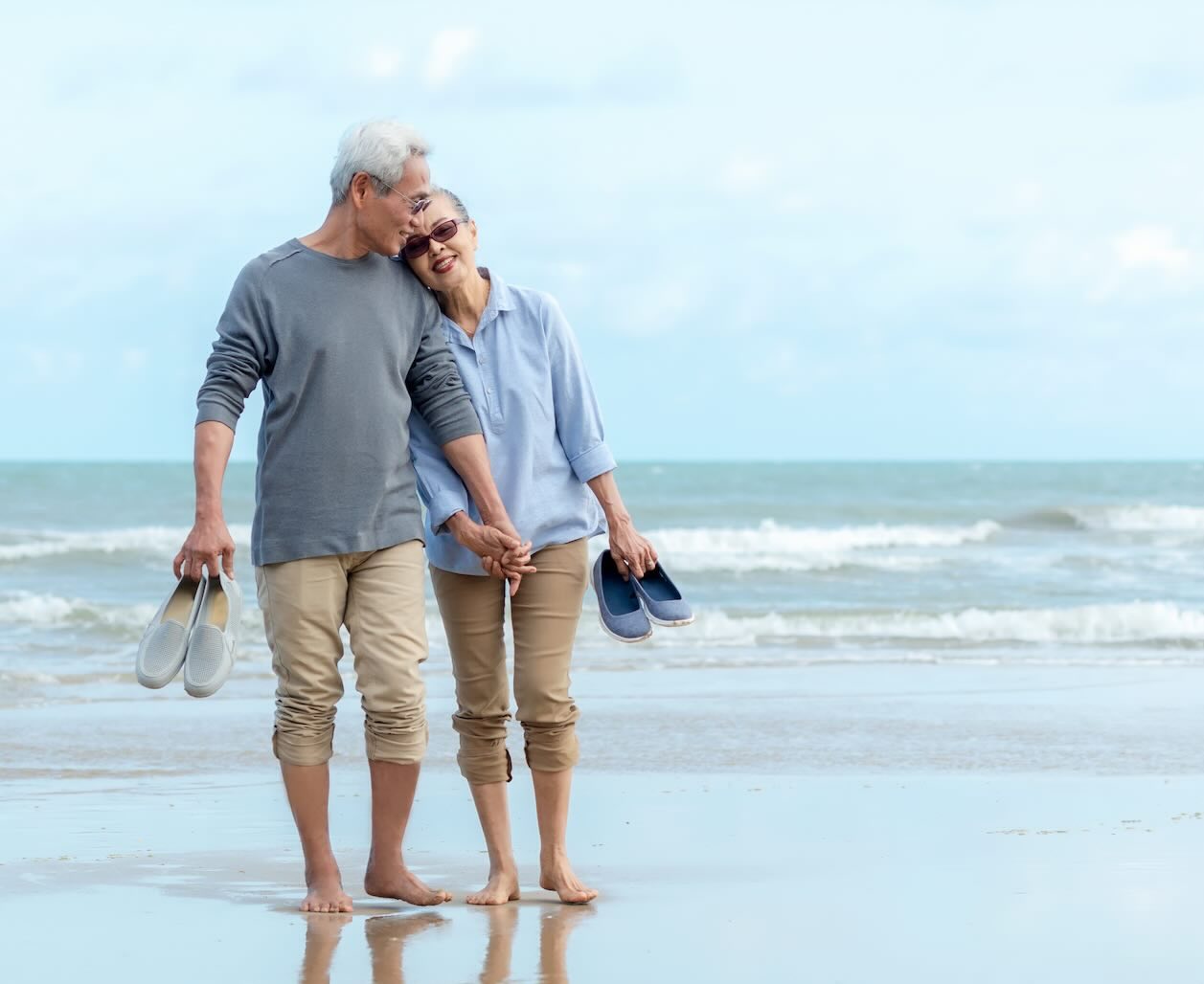 Senior couple at a beach walking